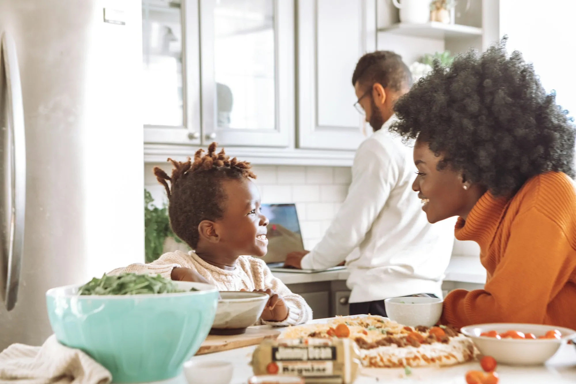 Family sharing a meal at a sunny kitchen table